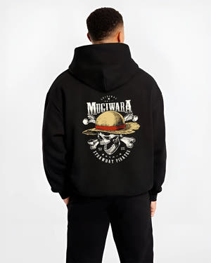 Black hoodie worn by a male model, back view, featuring One Piece Mugiwara skull and crossbones artwork in anime poster inspired design with retro streetwear vibe.