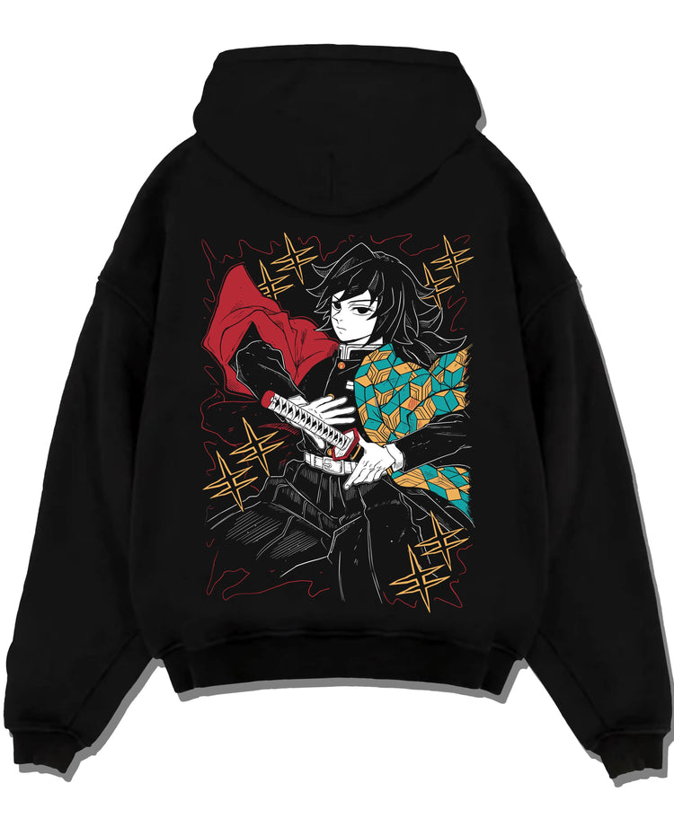Black pullover hoodie laid flat with Demon Slayer Hoodie Giyu Tomioka Swift Strike Jumper graphic bold anime graphic.