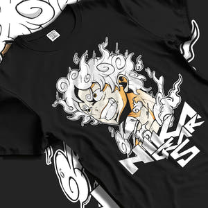 Black T-shirt laid flat with natural fabric folds, featuring One Piece Luffy Gear 5 anime poster style design.