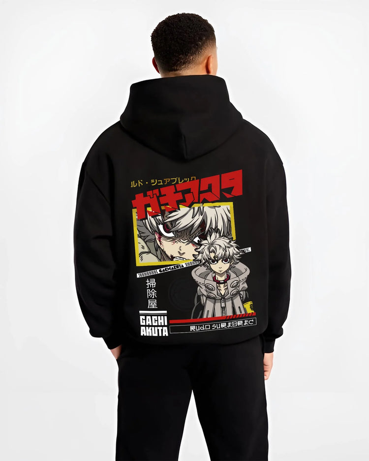 Black hoodie worn by male model, back view with Rudo Hoodie Gachiakuta Crouch Pose Graphic graphic premium wear.