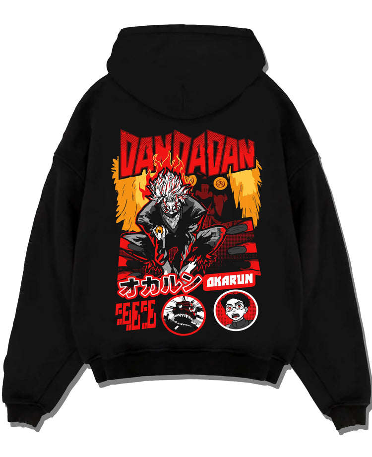 Black pullover hoodie laid flat with Okarun Hoodie Dandadan Possessed Spirit Alien Fight graphic premium wear.