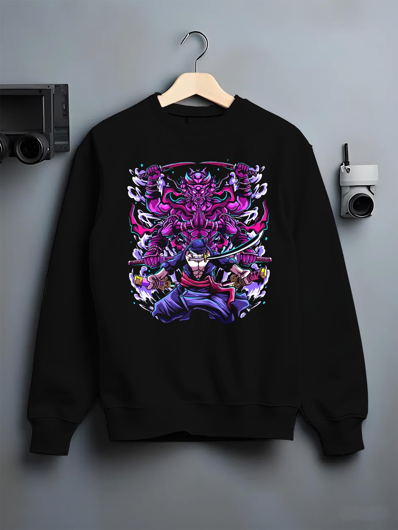 Black crewneck sweatshirt on a hanger against a grey wall, featuring Zoro Susanoo Japanese animation streetwear design with glowing purple shonen battle aura.