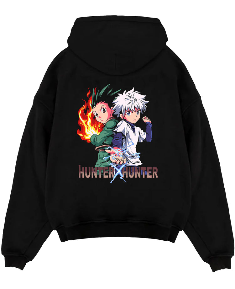 Black pullover hoodie laid flat on white, featuring Hunter x Hunter Gon and Killua retro manga graphic with pixel-style energy effects.