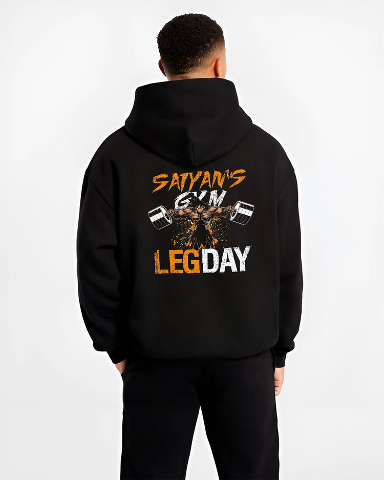 Black hoodie worn by a male model, back view, featuring Saiyan’s Gym Leg Day anime poster inspired design with bold weightlifting shonen battle character.