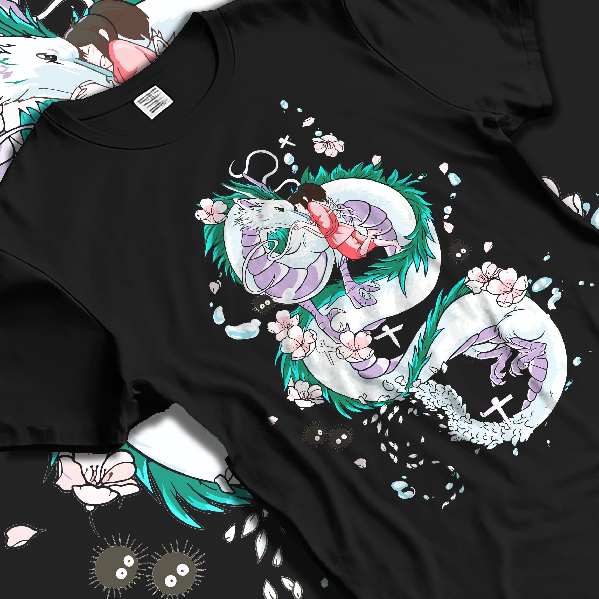 Black T-shirt laid flat with natural folds, featuring Spirited Away inspired design of Haku dragon and cherry blossoms in Japanese animation streetwear style.