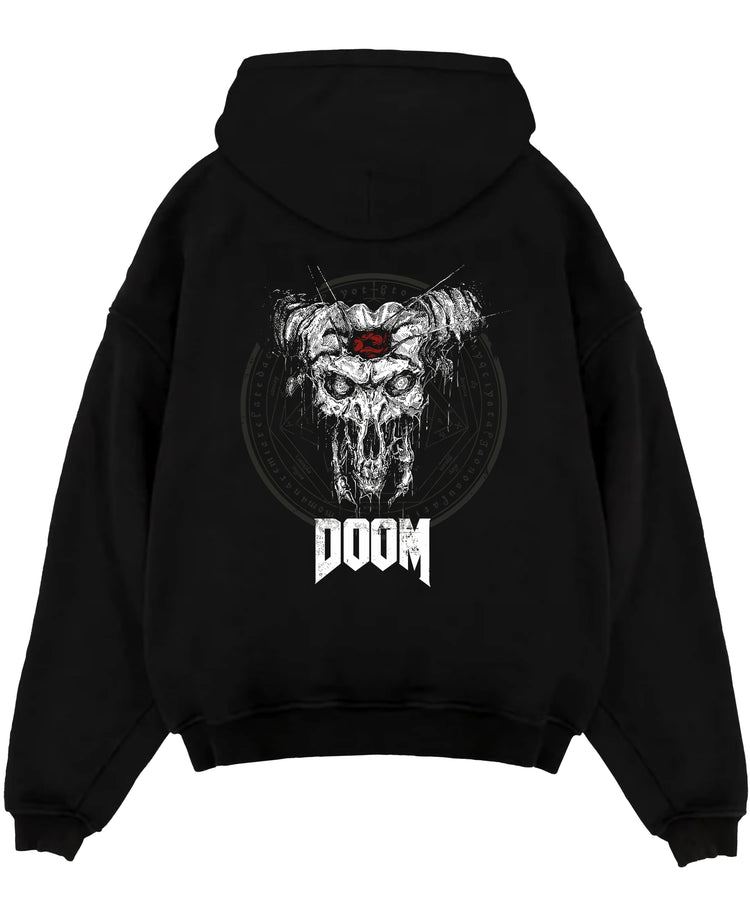 Black pullover hoodie laid flat on a white background, featuring DOOM demonic skull artwork with horns in distressed horror style and apocalyptic poster aesthetic.