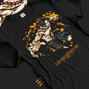 Black T-shirt laid flat with natural fabric folds, featuring One Piece Portgas D. Ace shonen battle character artwork in fiery Japanese animation streetwear style.