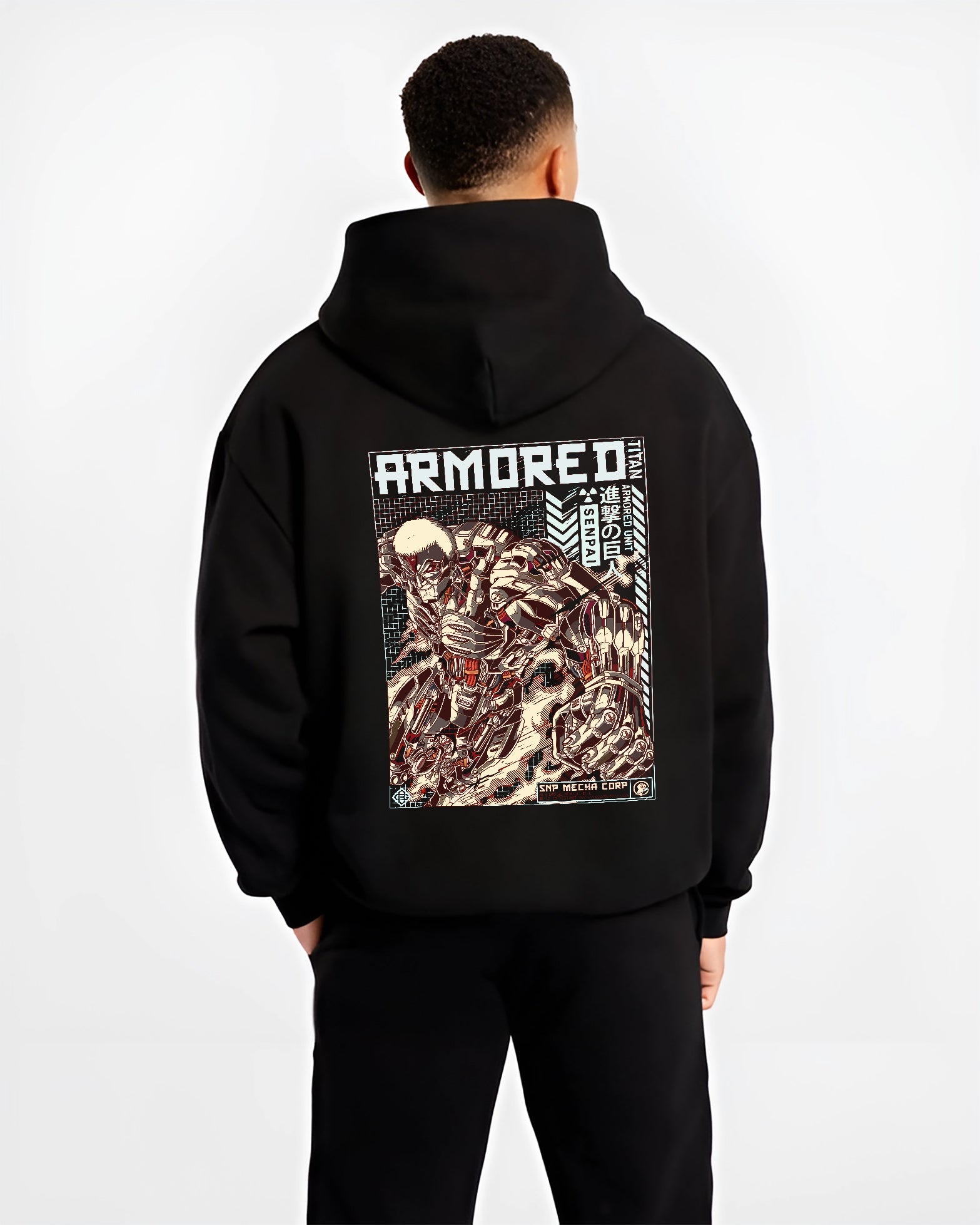 Black hoodie worn by a male model, back view, featuring Attack on Titan Armored Titan anime poster inspired artwork with gritty retro manga panel and armored detail.