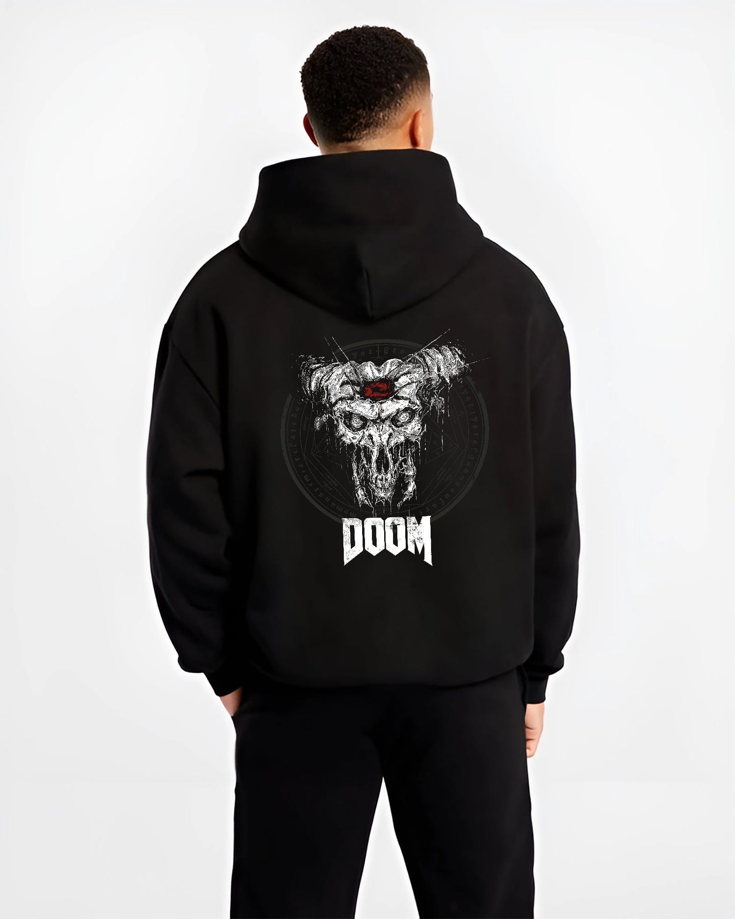 Black hoodie worn by a male model, back view, featuring DOOM horned skull graphic with gritty detail and retro video game horror poster inspired artwork.