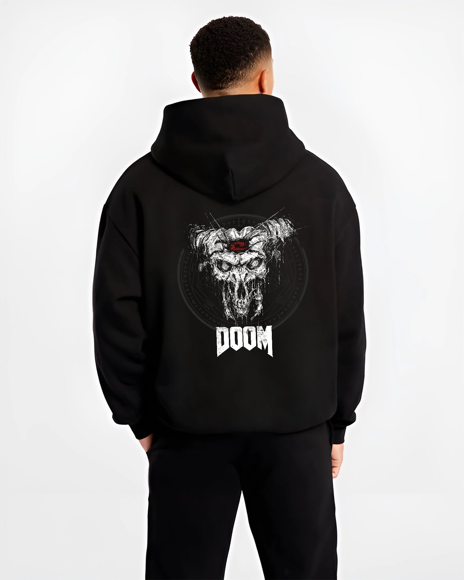 Black hoodie worn by a male model, back view, featuring DOOM horned skull graphic with gritty detail and retro video game horror poster inspired artwork.