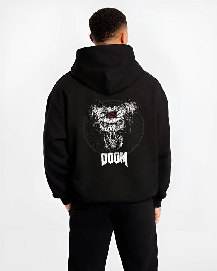 Black hoodie worn by a male model, back view, featuring DOOM horned skull graphic with gritty detail and retro video game horror poster inspired artwork.