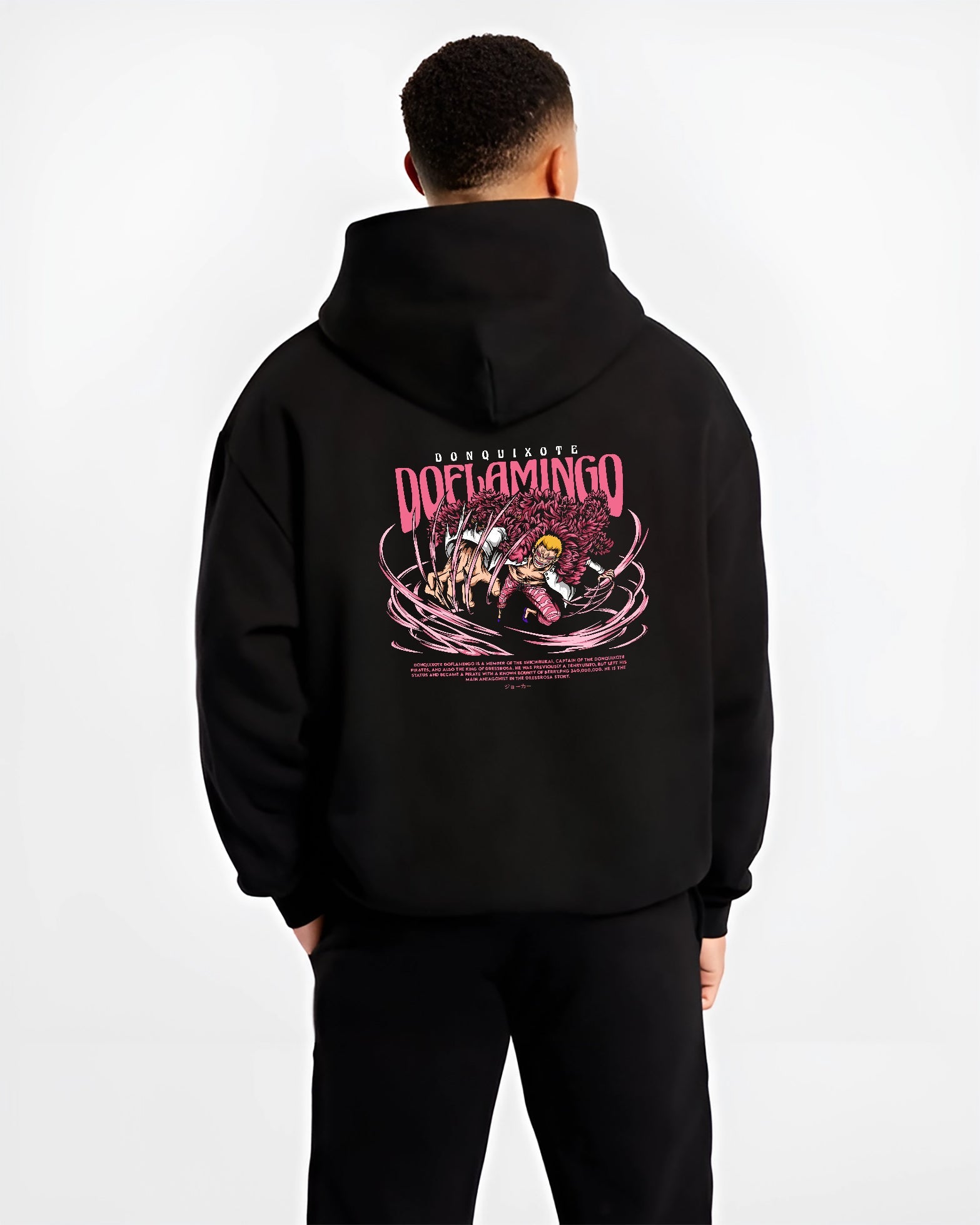 Black hoodie worn by a male model, back view, featuring One Piece Doflamingo anime poster inspired artwork with string powers in bold retro manga graphic style.