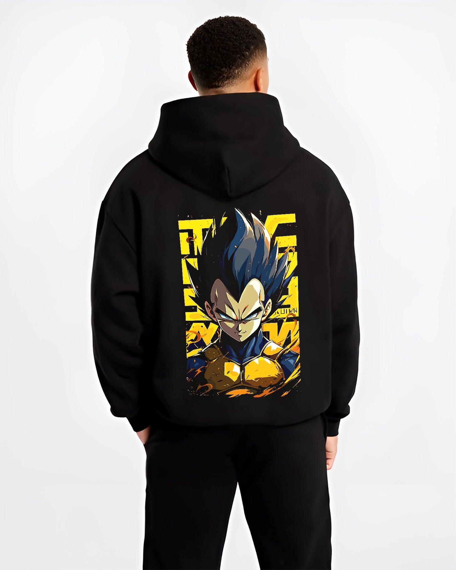 Black hoodie worn by a male model, back view, featuring Dragon Ball Vegeta anime poster inspired portrait artwork with yellow accent background in retro manga graphic style.