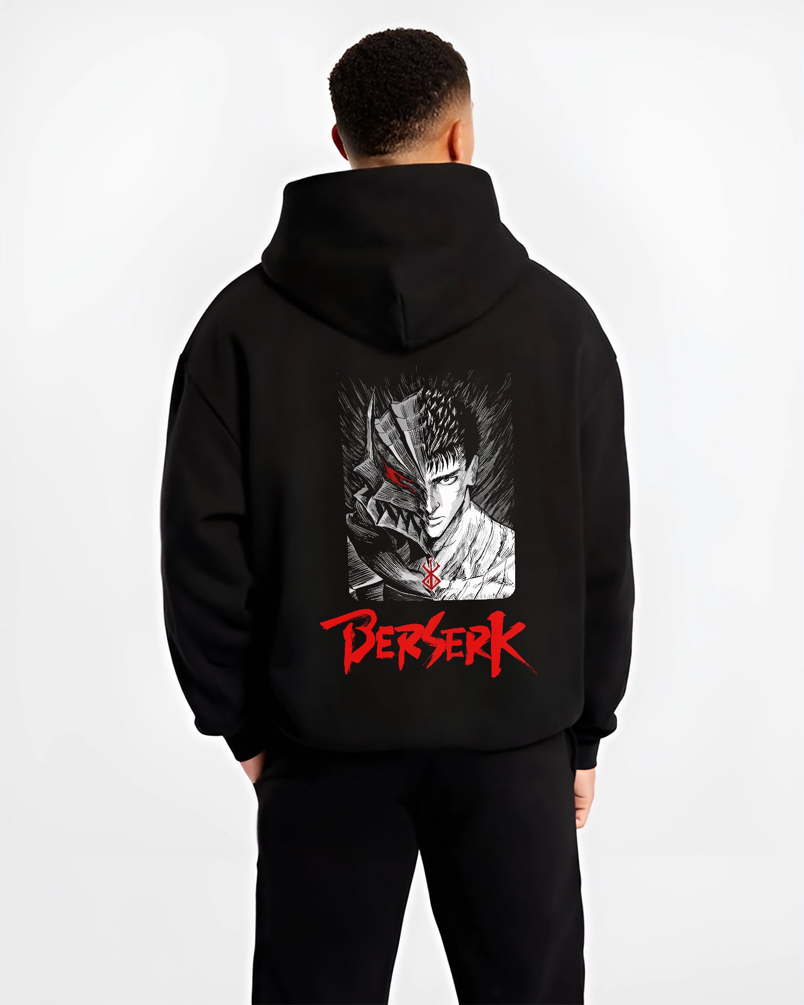 Black hoodie worn by a male model, back view, featuring Berserk Guts split portrait artwork in anime poster inspired retro manga graphic with gritty horror detail.