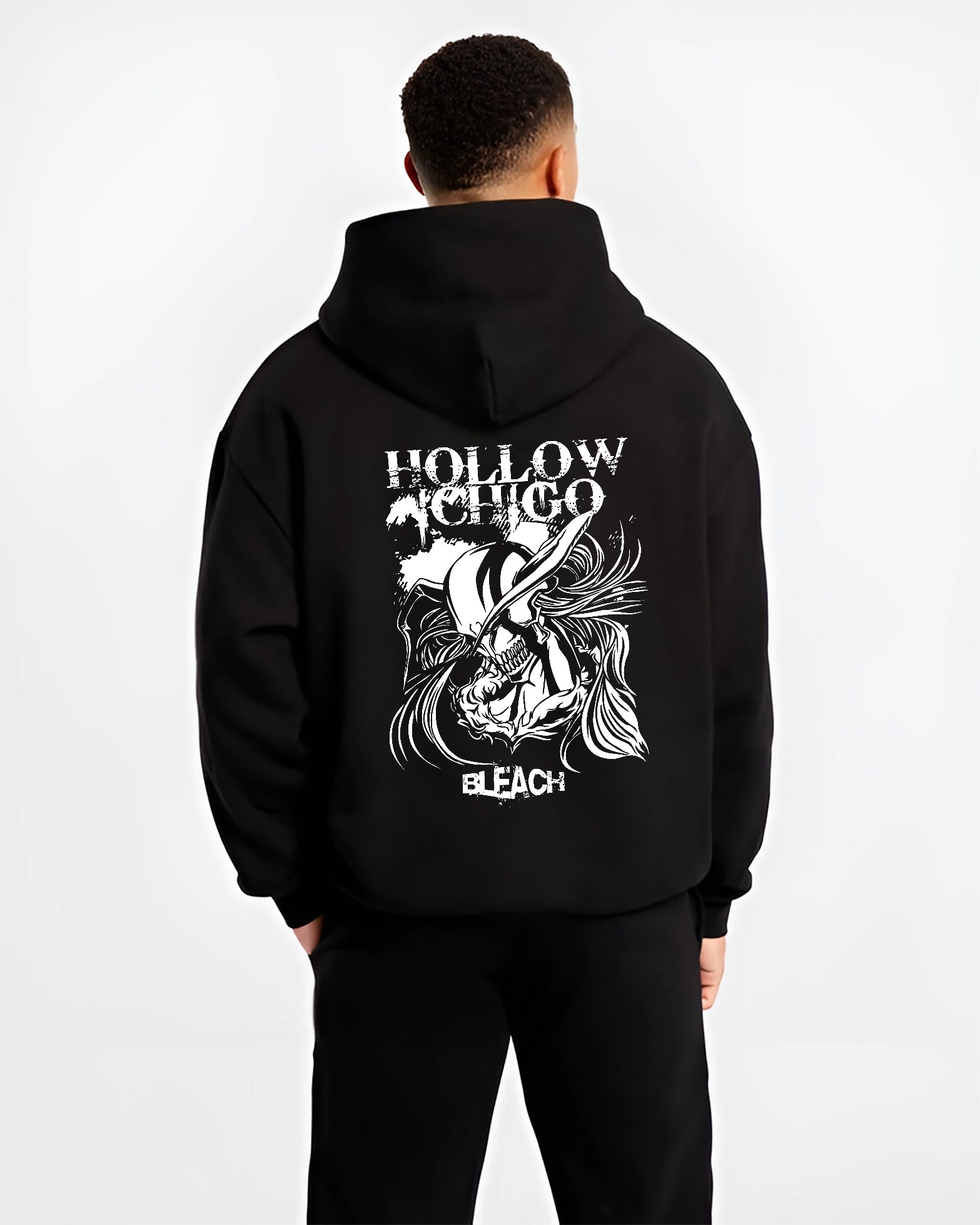 Black hoodie worn by a male model, back view, featuring Hollow Ichigo Bleach retro manga graphic with striking Japanese animation streetwear design.