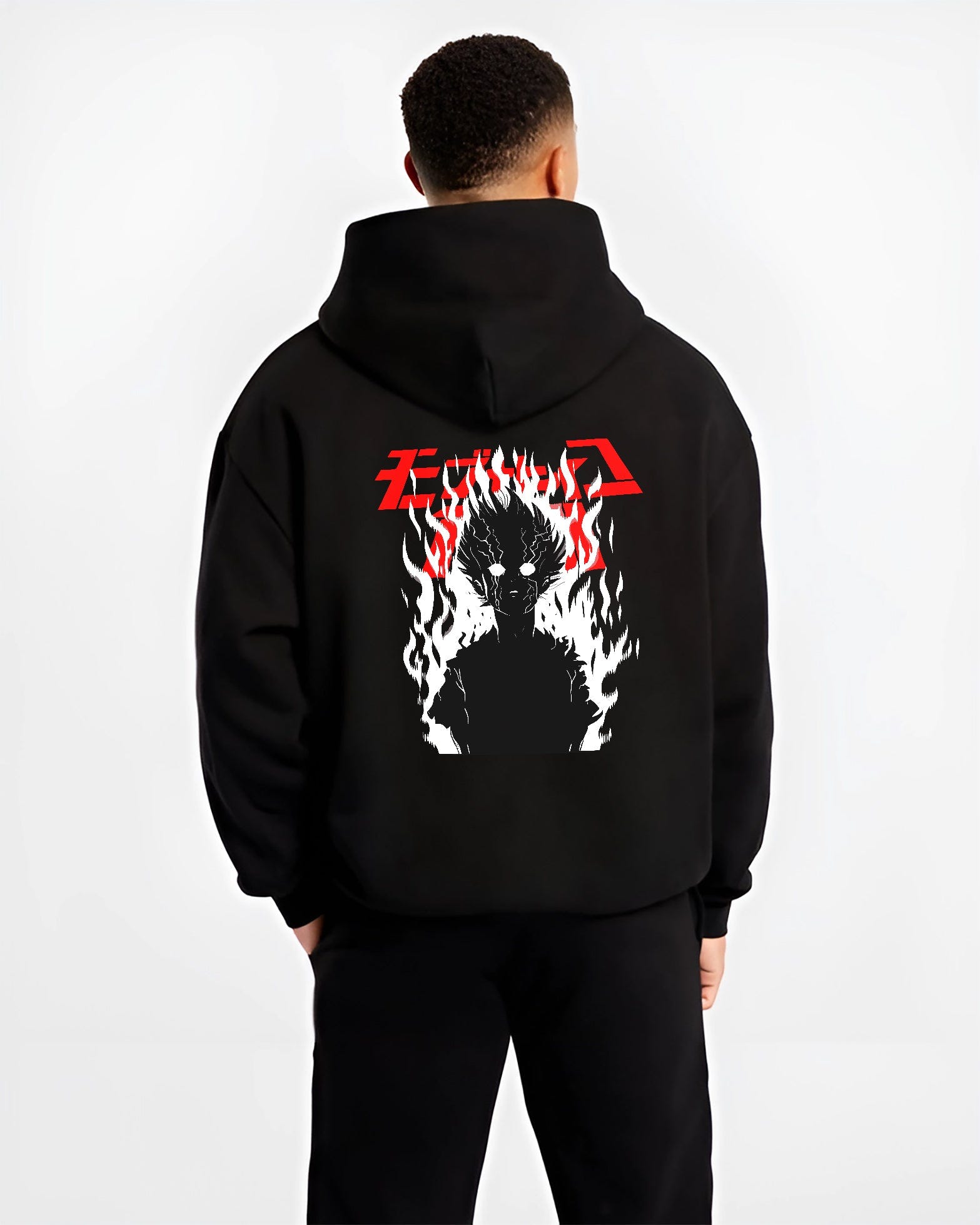 Black hoodie worn by a male model, back view, featuring Mob Psycho 100 fiery silhouette anime poster style artwork with dark manga aesthetic.