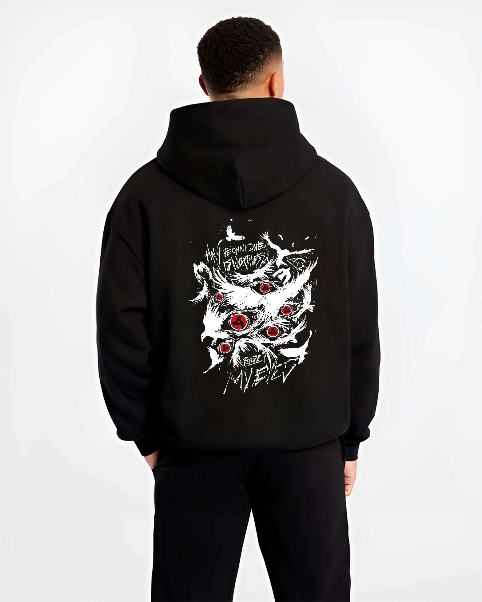 Black hoodie worn by a male model, back view, featuring Naruto Sharingan Japanese animation streetwear design with striking red eye graphics and distressed text.