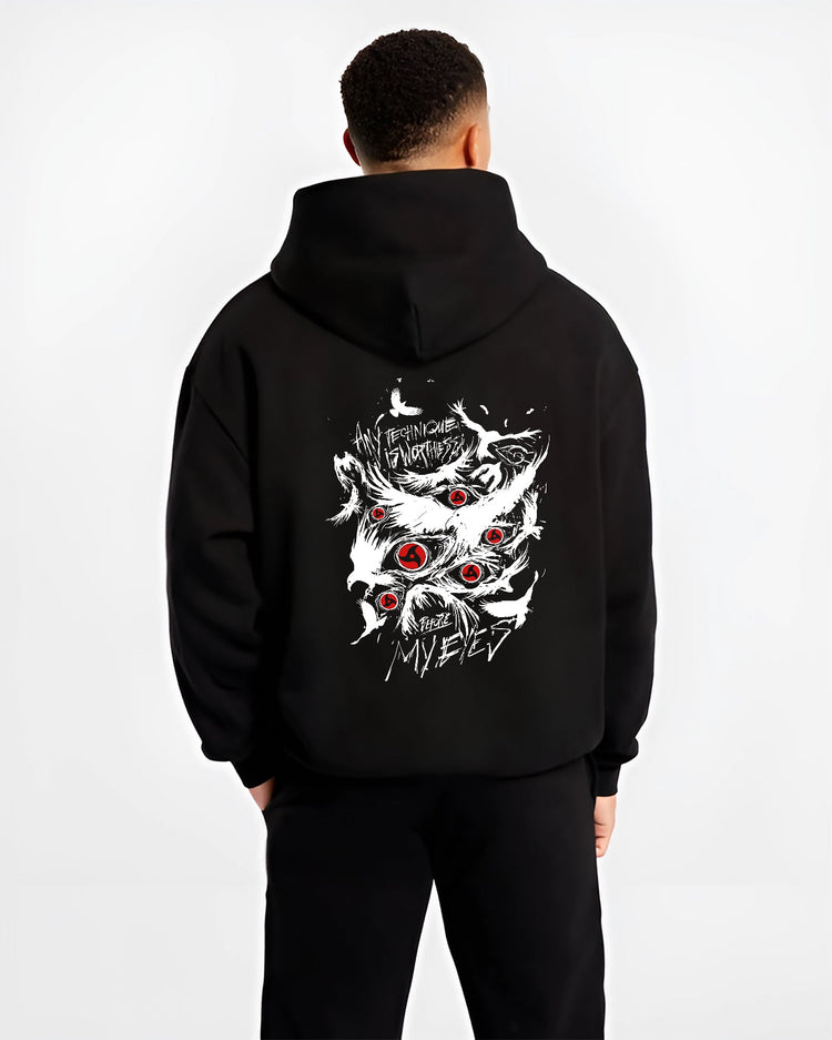 Black hoodie worn by a male model, back view, featuring Naruto Sharingan Japanese animation streetwear design with striking red eye graphics and distressed text.