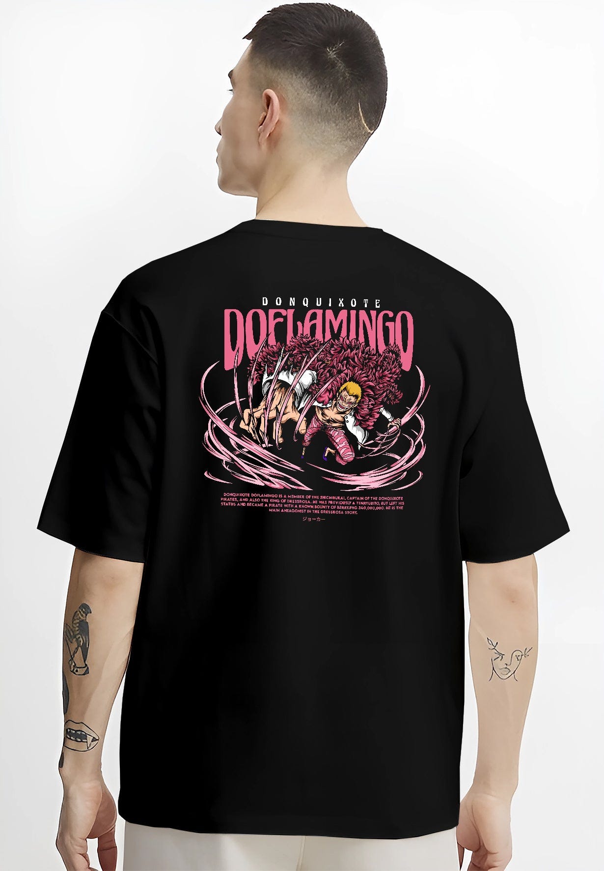 Black T-shirt worn by a male model, back view, featuring One Piece Doflamingo anime poster inspired artwork with string powers in retro manga style and bold details.