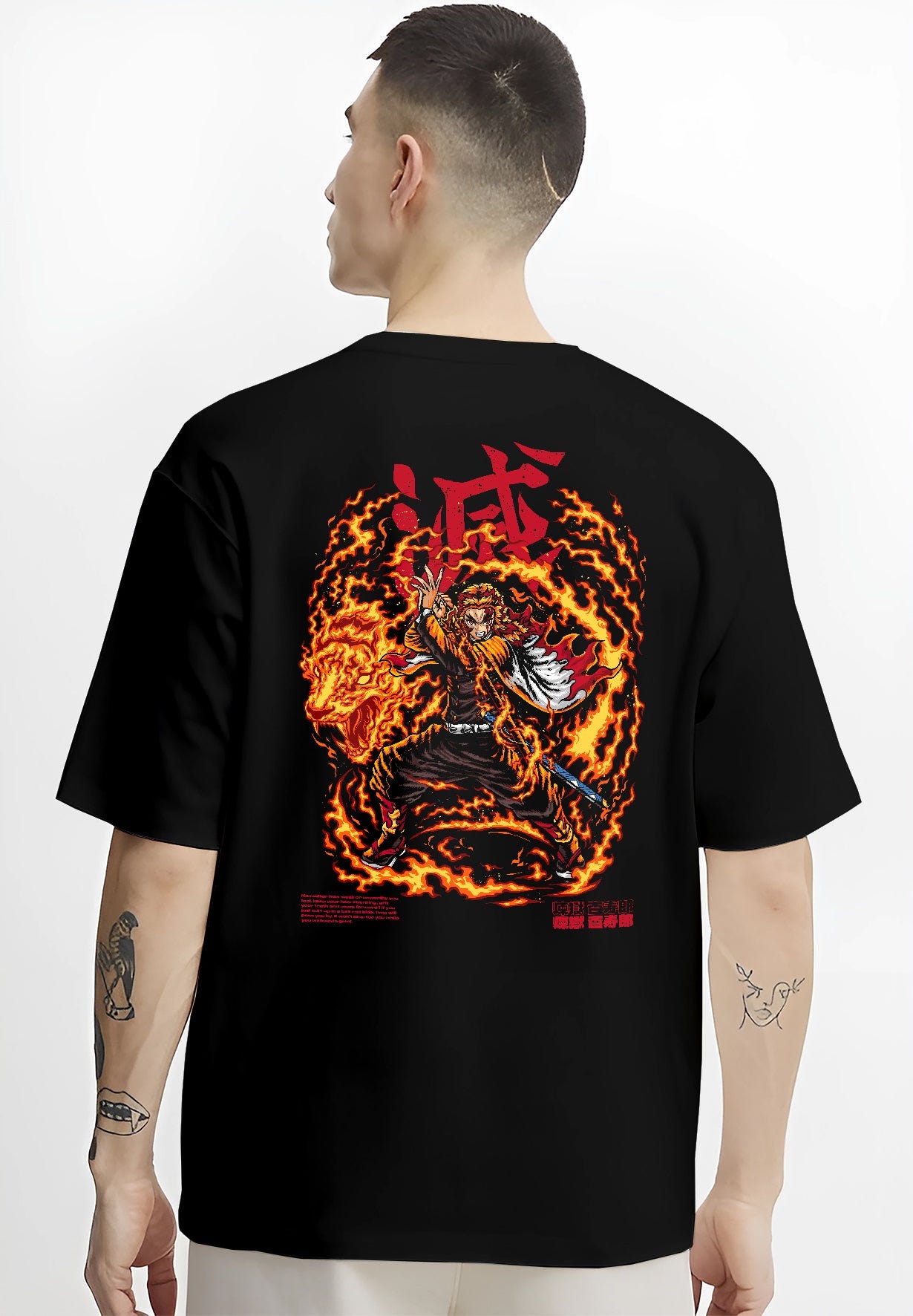 Black T-shirt worn by a male model, back view, featuring Demon Slayer Rengoku anime poster inspired artwork with blazing flame aura in bold shonen battle manga style.