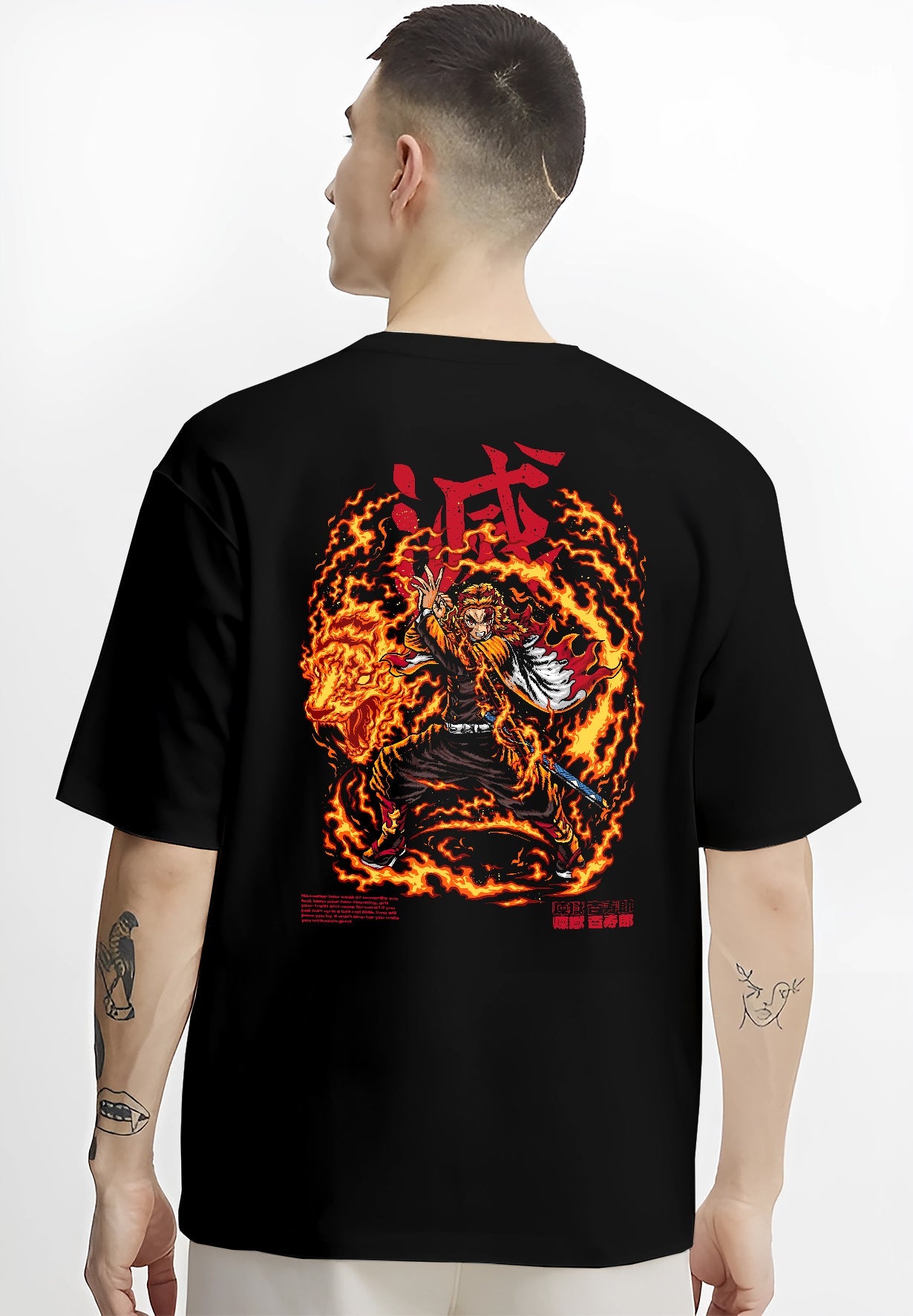 Black T-shirt worn by a male model, back view, featuring Demon Slayer Rengoku anime poster inspired artwork with blazing flame aura in bold shonen battle manga style.