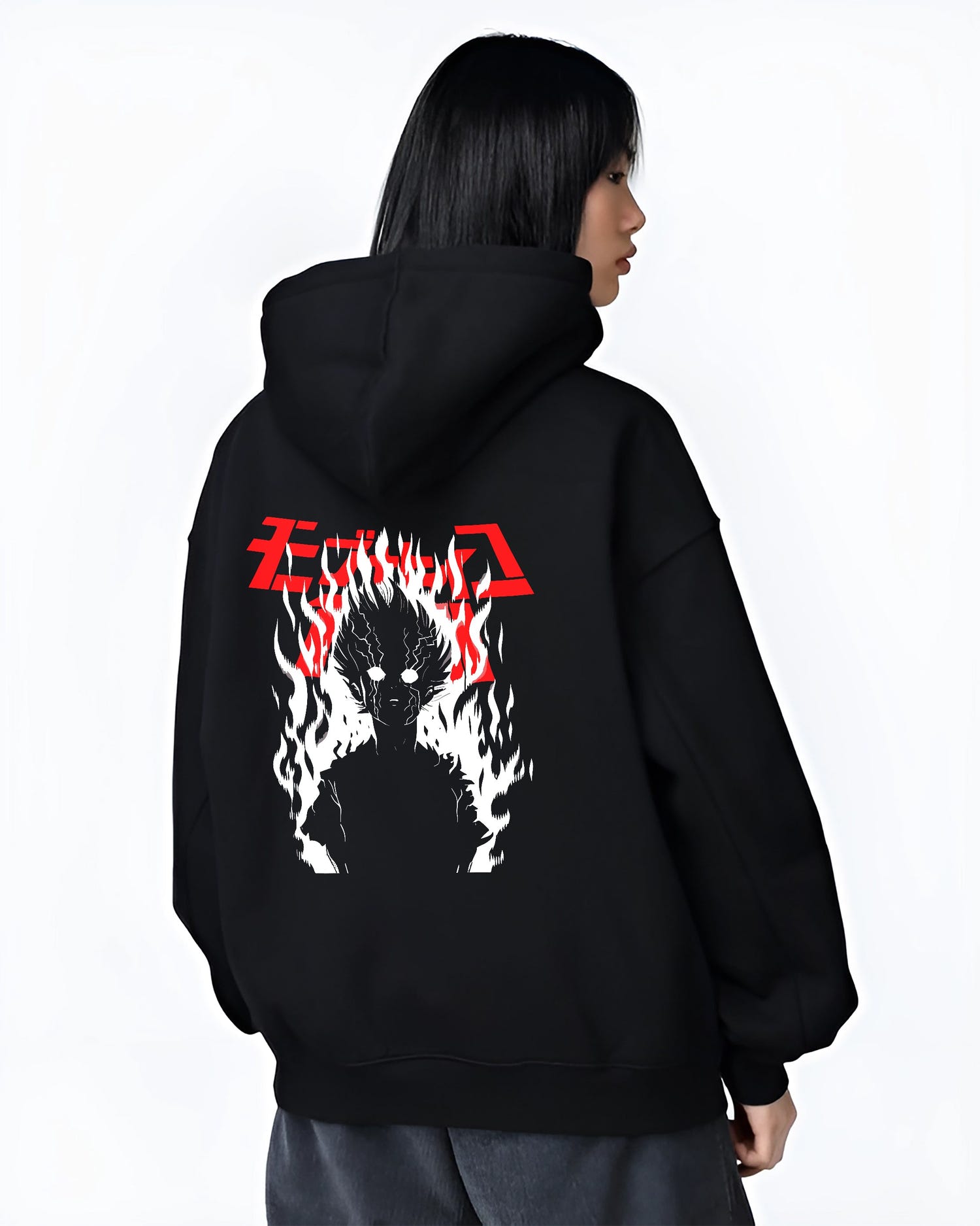 Black hoodie worn by a female model, back view, featuring Mob Psycho 100 silhouette engulfed in flames retro streetwear inspired manga artwork.