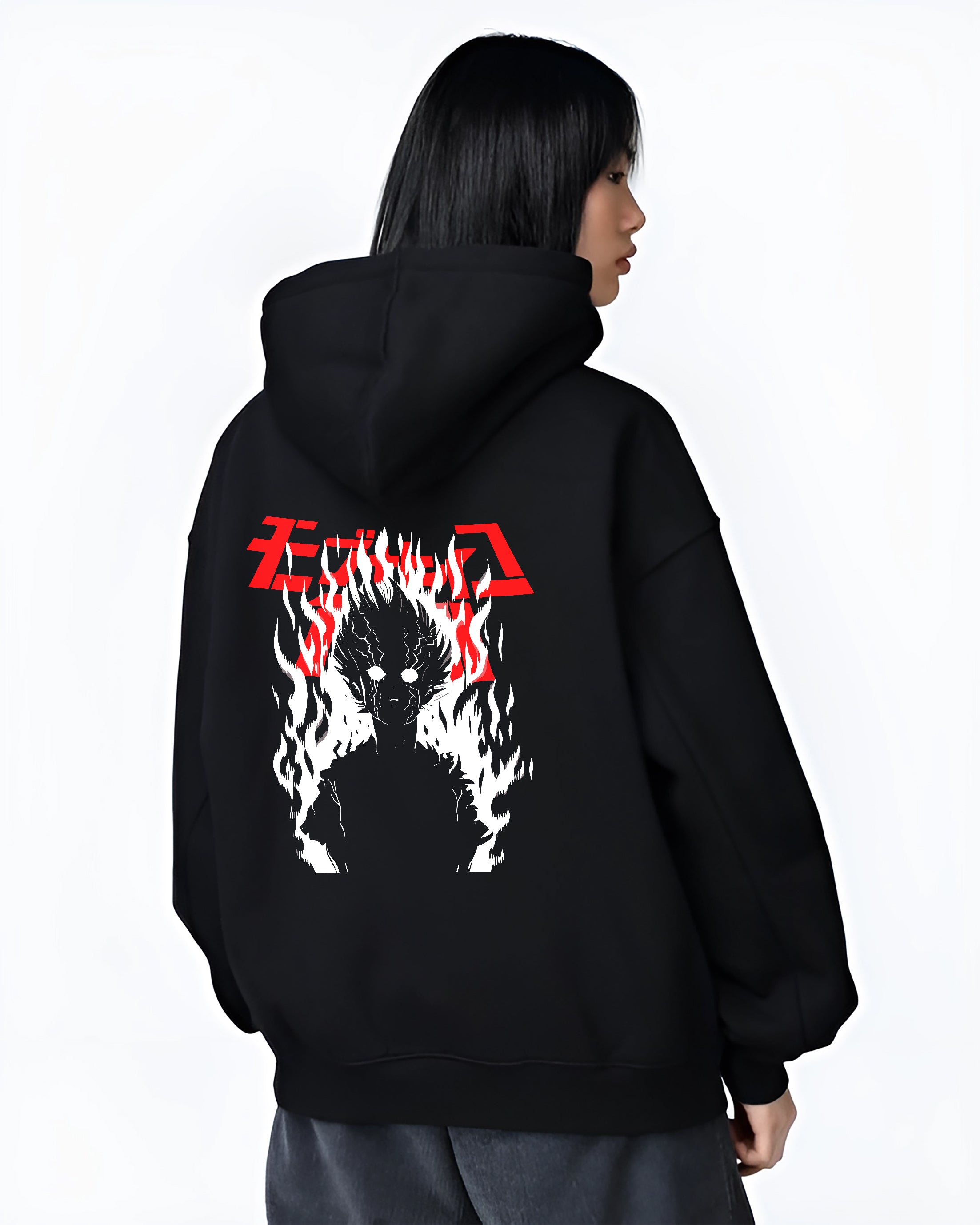 Black hoodie worn by a female model, back view, featuring Mob Psycho 100 silhouette engulfed in flames retro streetwear inspired manga artwork.