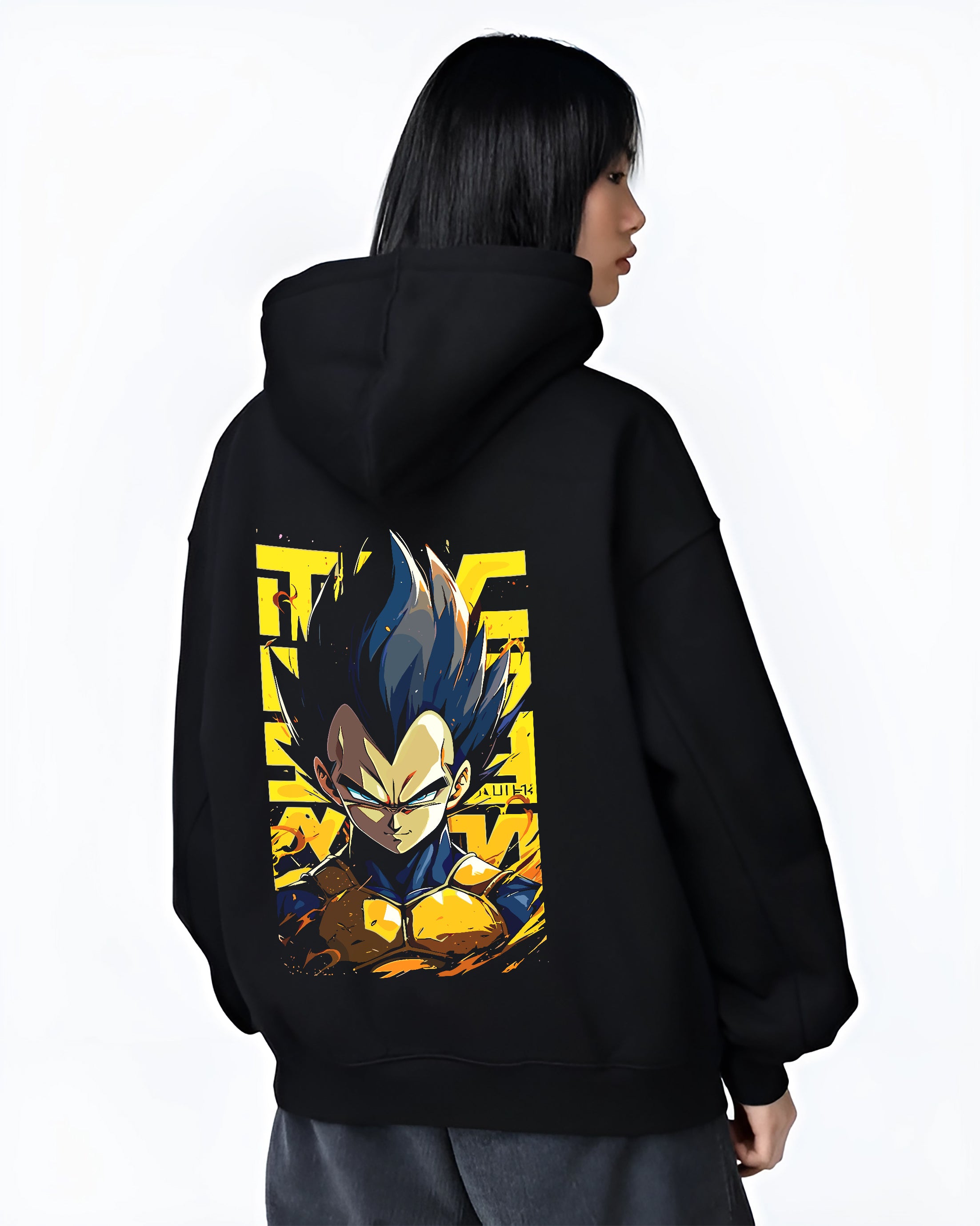 Black hoodie worn by a female model, back view, featuring Dragon Ball Vegeta retro manga graphic portrait with bold yellow background in anime poster inspired artwork style.