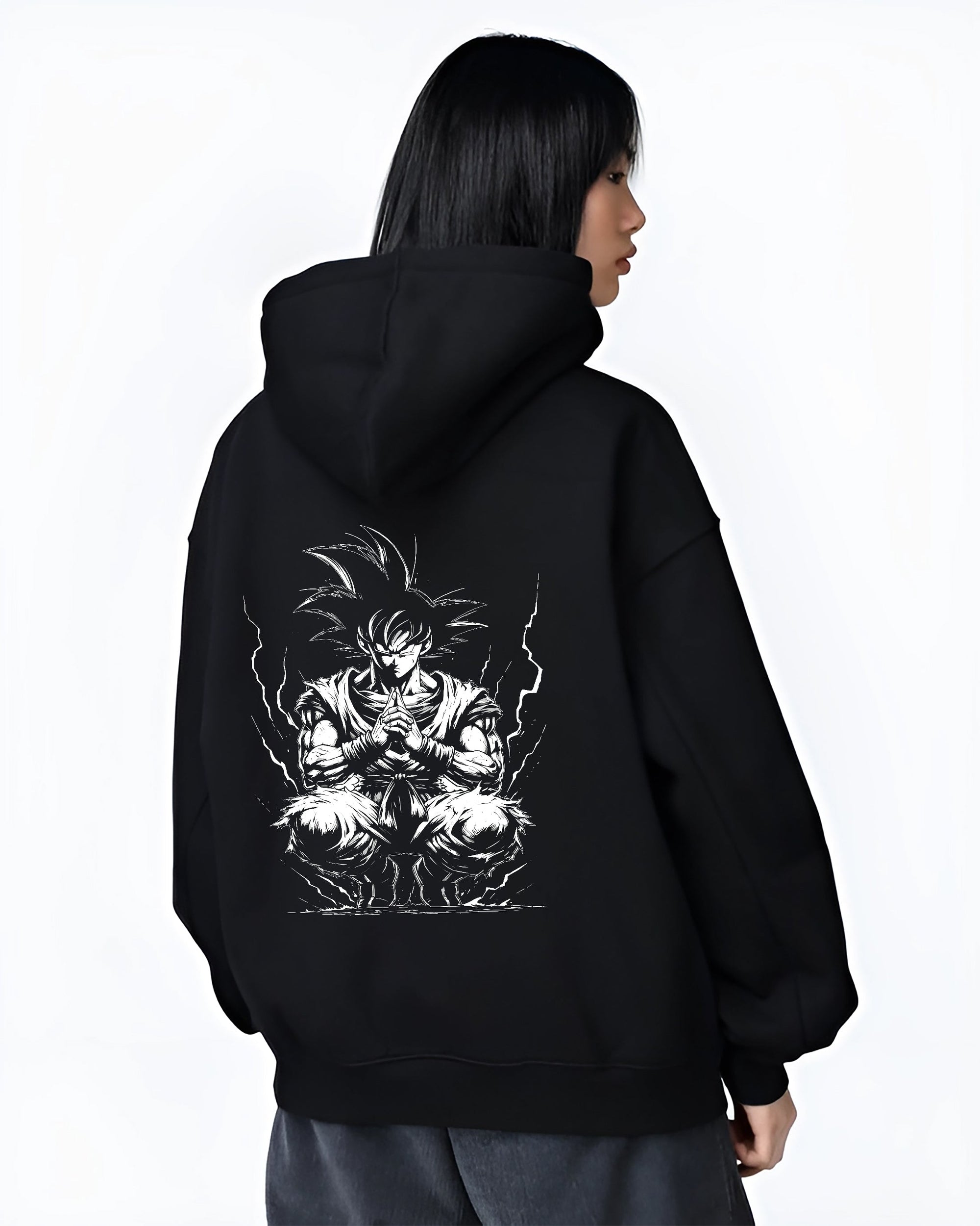Black hoodie worn by a female model, back view, featuring Dragon Ball Goku anime poster inspired artwork with meditation stance and lightning aura in dark manga style.