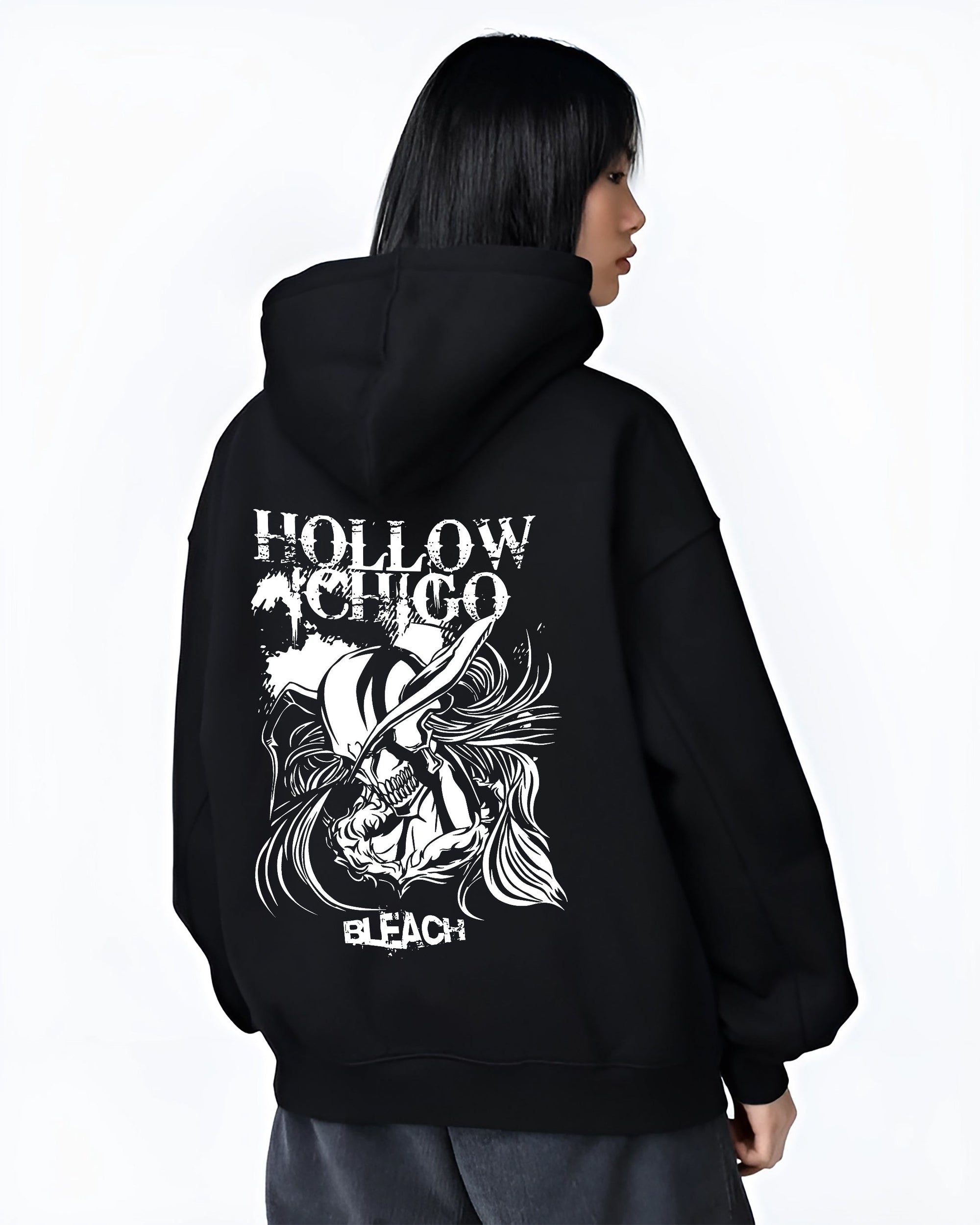 Black hoodie worn by a female model, back view, featuring Hollow Ichigo Bleach dark manga panel design with bold Japanese animation streetwear vibe.