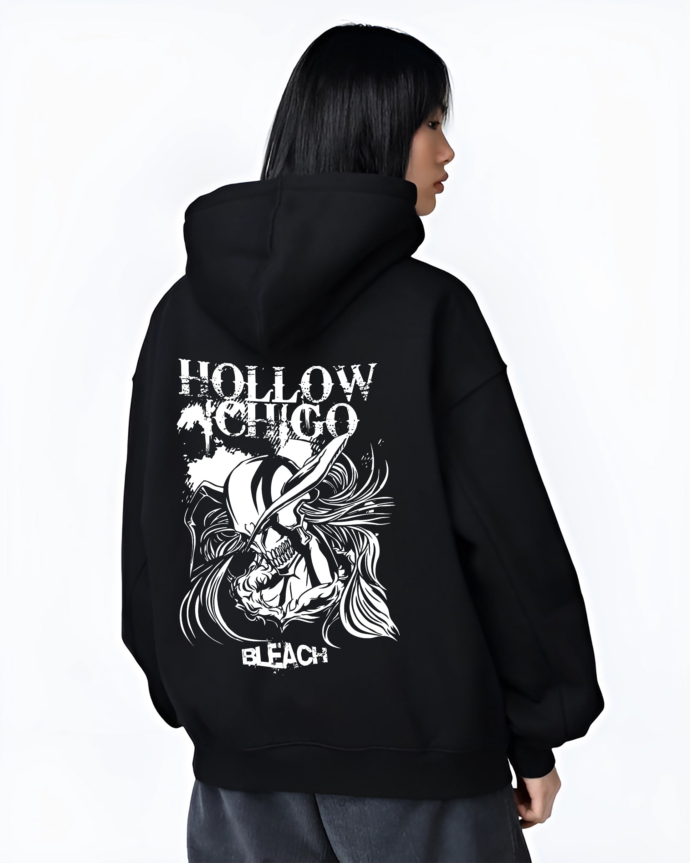 Black hoodie worn by a female model, back view, featuring Hollow Ichigo Bleach dark manga panel design with bold Japanese animation streetwear vibe.