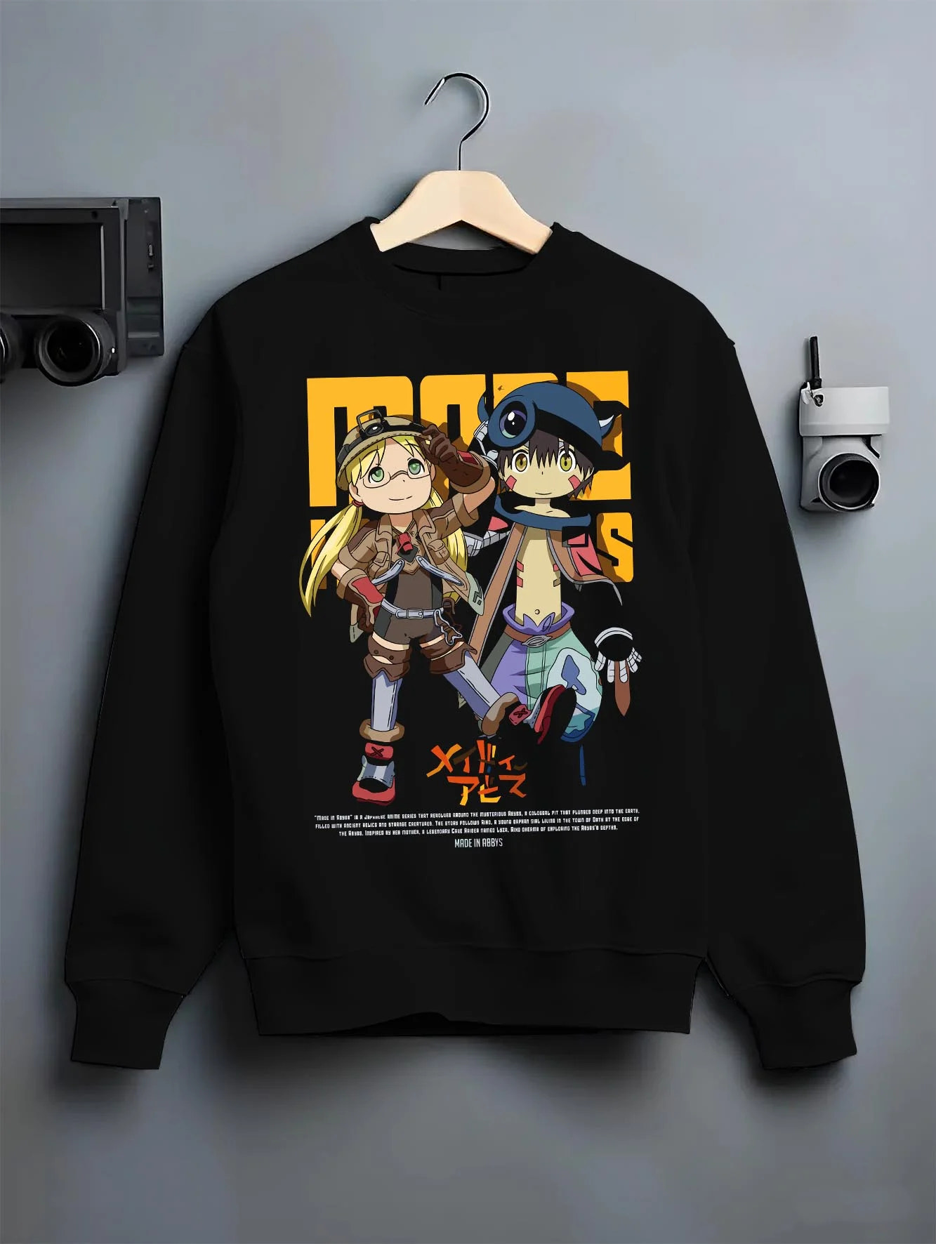 Black crewneck sweatshirt on hanger with Made in Abyss Explorer Hoodie Cave Adventure Jumper graphic streetwear graphic.