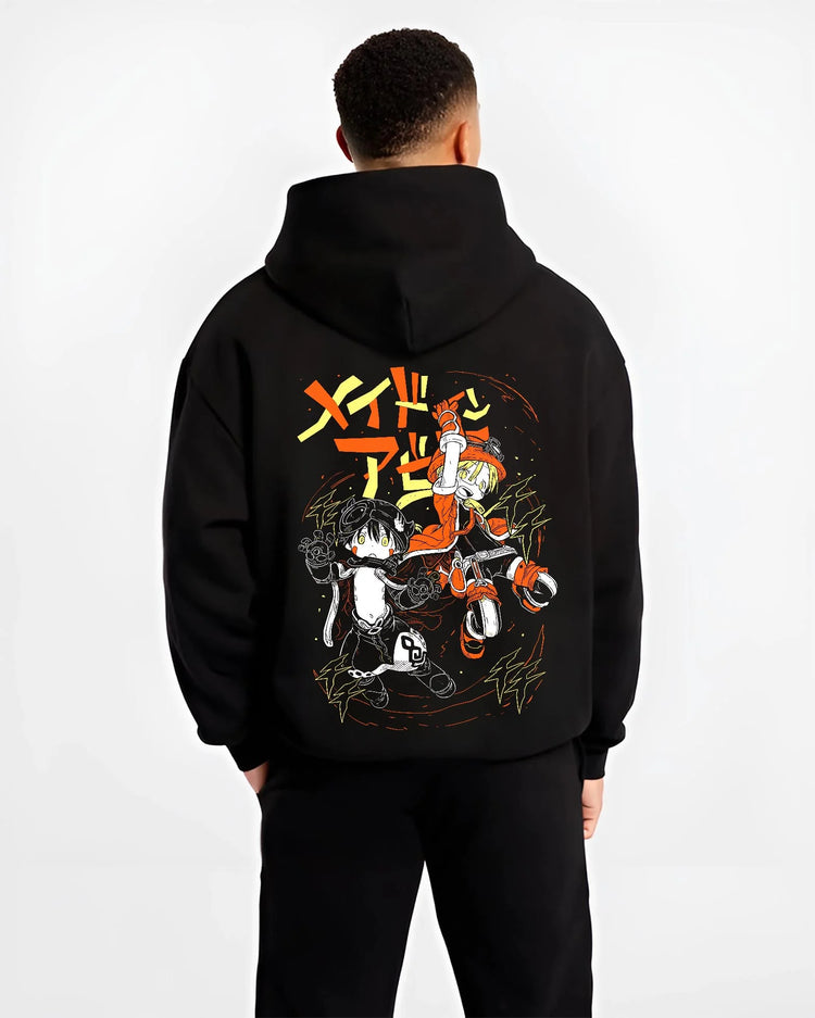Black hoodie worn by a male model, back view, featuring Riko and Reg retro manga graphic with energetic lightning strokes in Japanese animation streetwear.