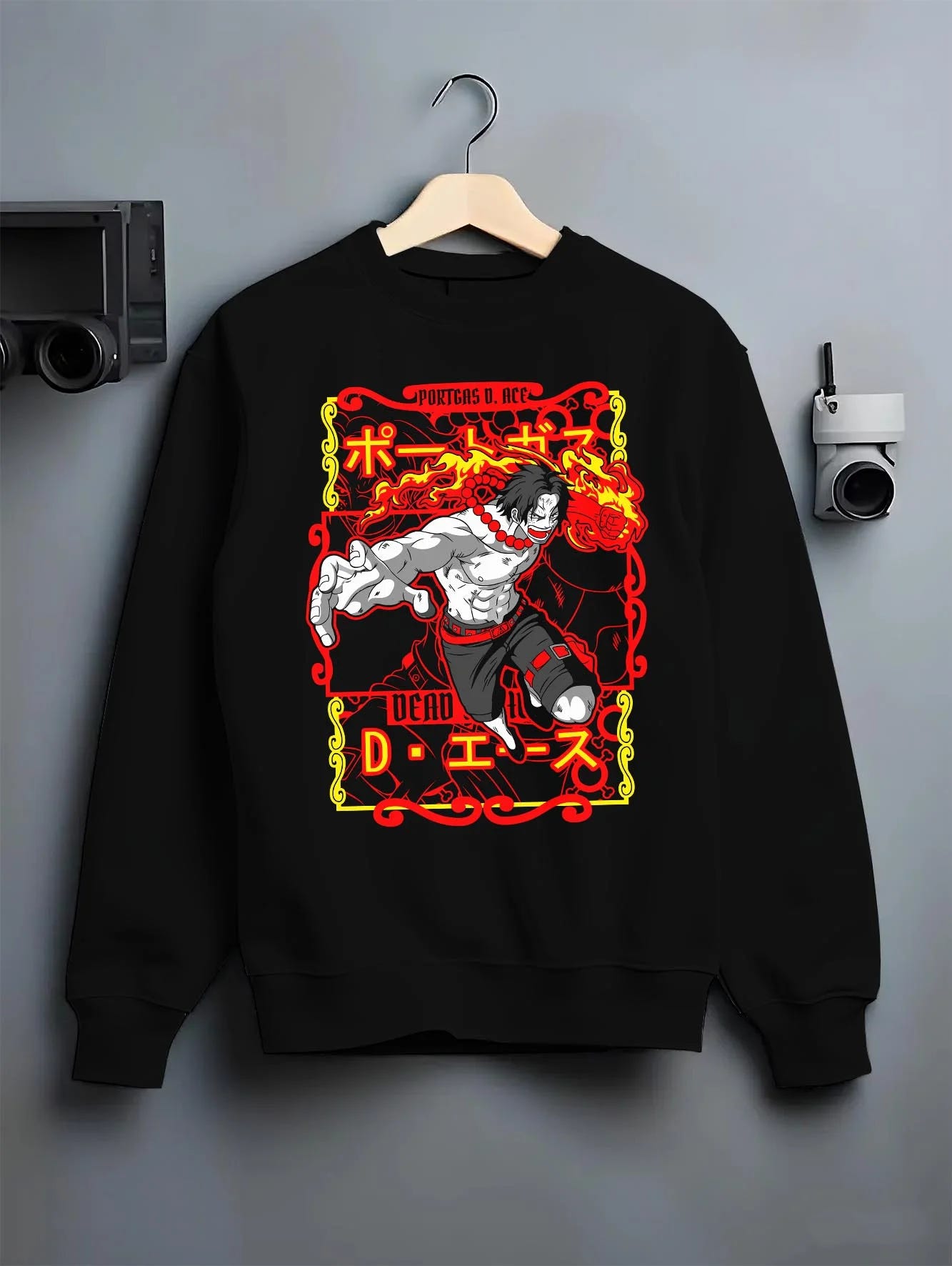 Black crewneck sweatshirt on hanger, featuring Portgas D. Ace anime streetwear flame graphic in bold retro manga style