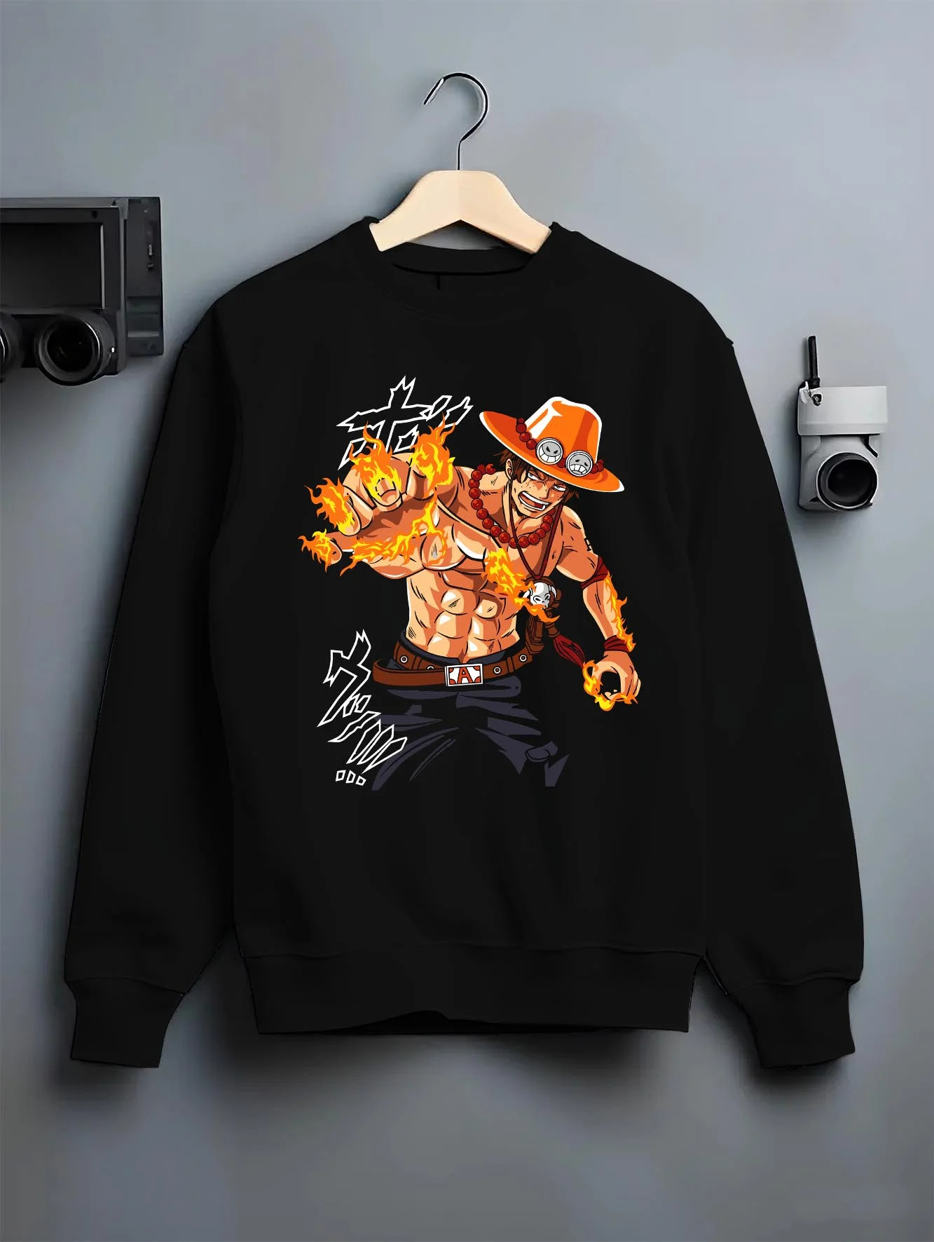 Black crewneck sweatshirt on hanger with Portgas Ace Blaze Hoodie One Piece Ember Aura Flames graphic bold anime graphic.