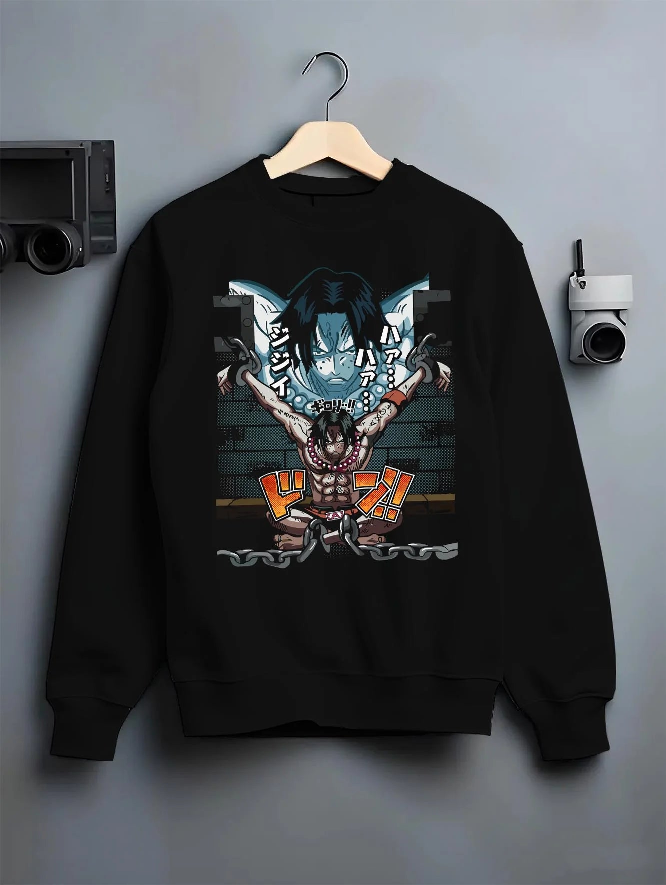 Black crewneck sweatshirt on hanger with Portgas Ace Chains Hoodie One Piece Prison Cell Flames graphic streetwear graphic.