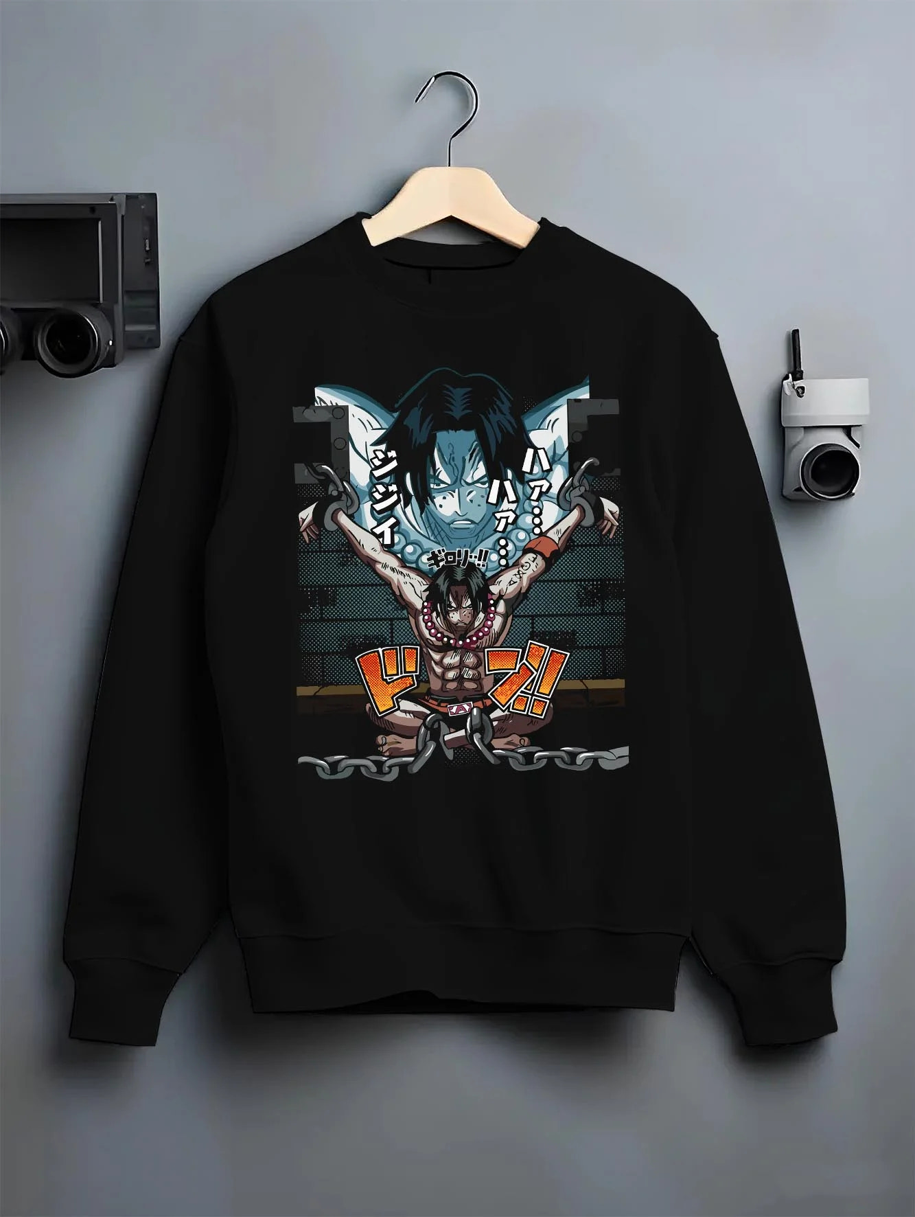 Black crewneck sweatshirt on hanger with Portgas Ace Chains Hoodie One Piece Prison Cell Flames graphic streetwear graphic.