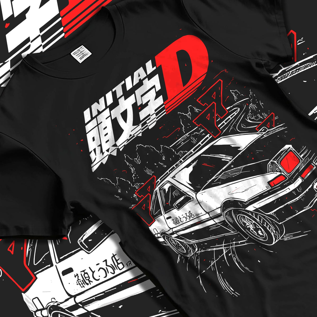 Black T-shirt laid flat with natural folds featuring Takumi Fujiwara AE86 Initial D drift racing artwork.