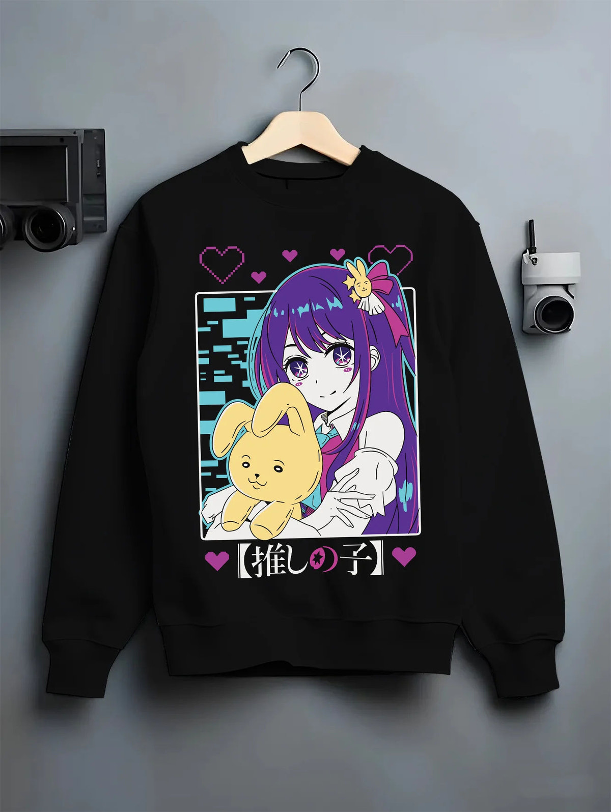 Black crewneck sweatshirt on hanger showing Ai Hoshino from Oshi no Ko: purple-haired girl with plush toy