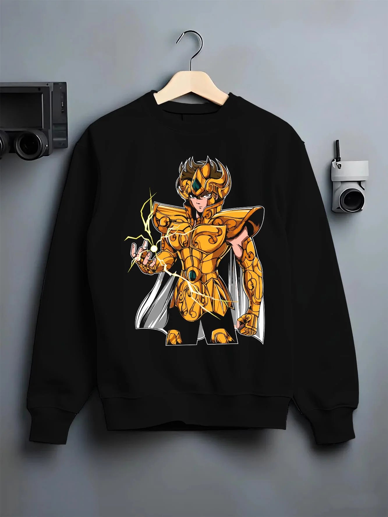Black crewneck sweatshirt on hanger with Leo Gold Saint Hoodie Saint Seiya Celestial Zodiac graphic premium wear.