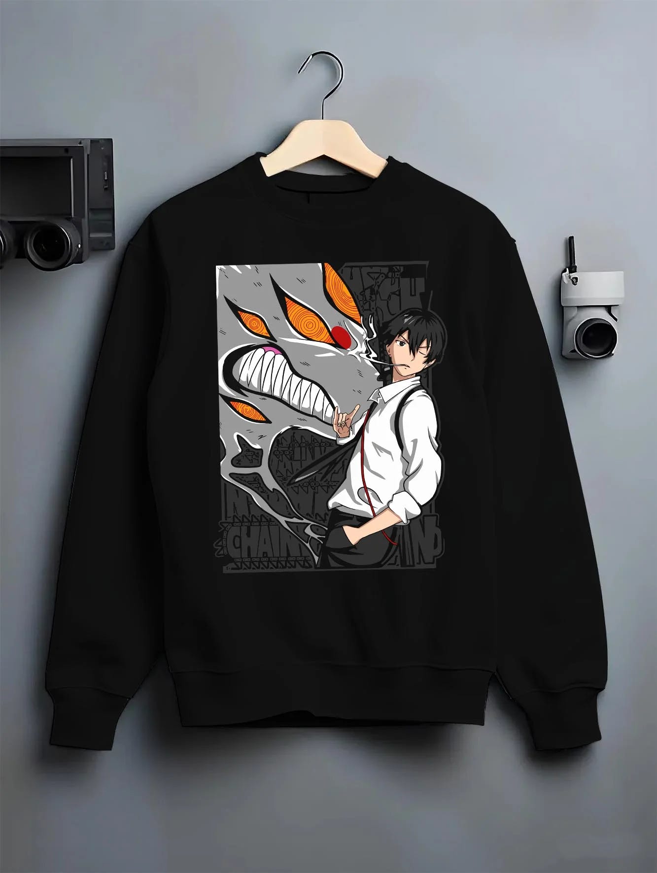 Black crewneck sweatshirt on hanger with Chainsaw Man Hoodie Denji Devil Hunter Chainsaw Blades graphic Denji anime design.