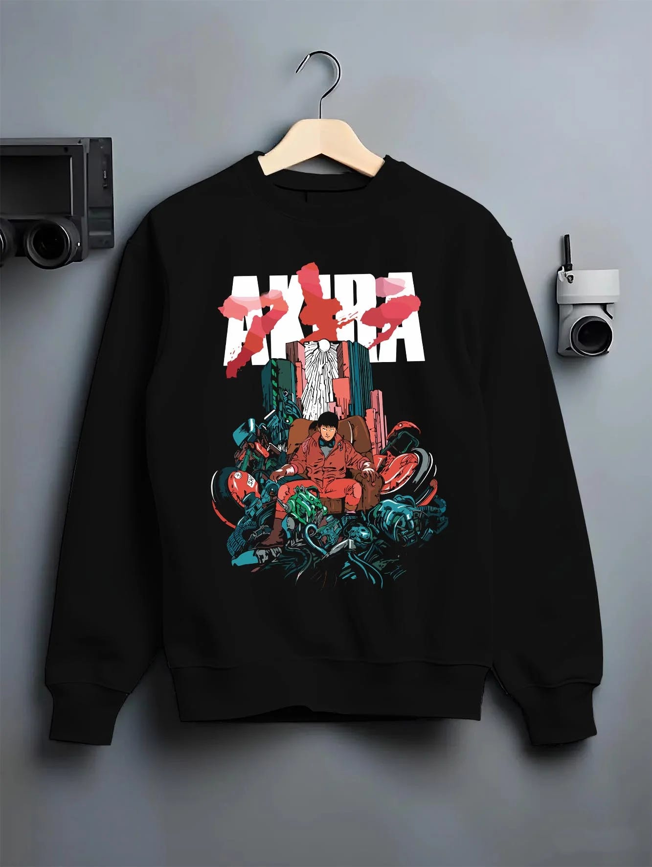 Black crewneck sweatshirt on hanger with Akira Neo Tokyo Hoodie Capsule Motorcycle Retro Panel graphic premium wear.