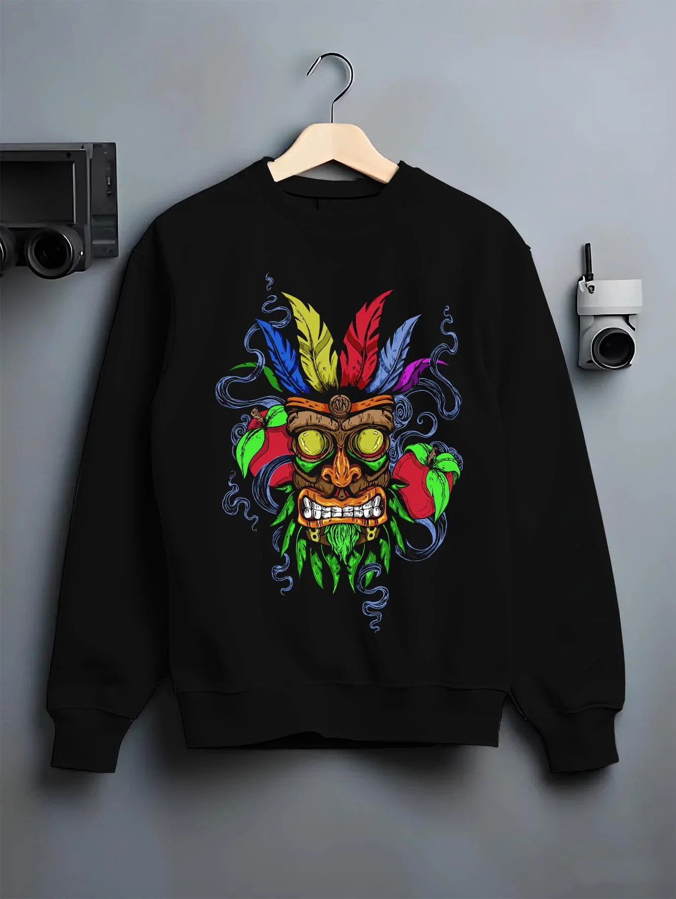 Black crewneck sweatshirt on hanger with Crash Bandicoot Aku Aku Hoodie Retro Gaming Classic graphic premium wear.