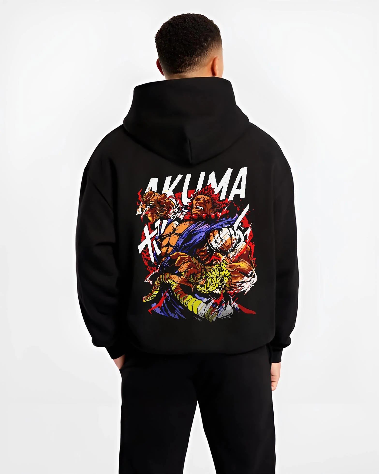 Black hoodie worn by male model, back view with Akuma Max Power Hoodie Street Fighter Fiery Demon Aura graphic streetwear graphic.