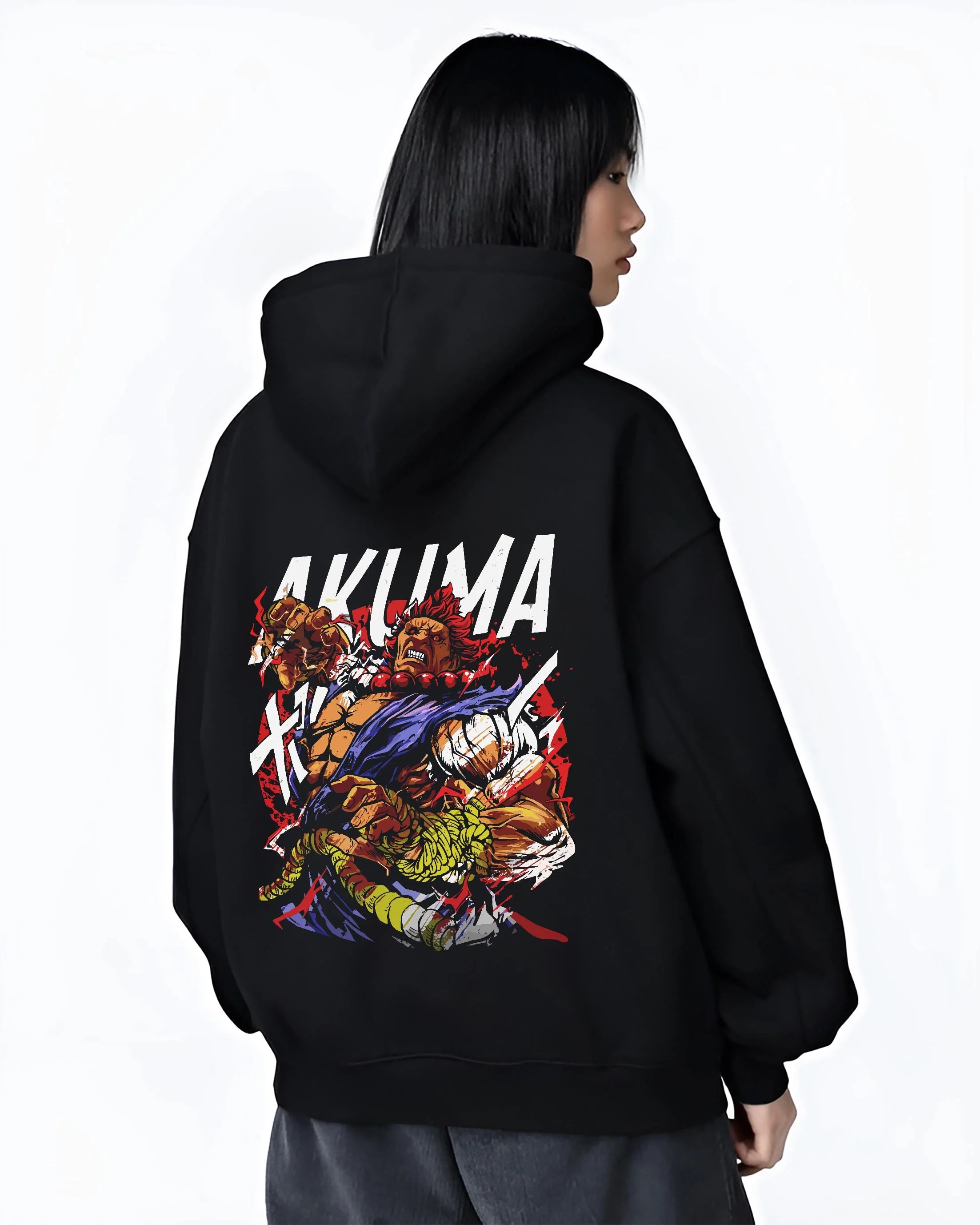 Black hoodie worn by female model, back view with Akuma Max Power Hoodie Street Fighter Fiery Demon Aura graphic bold anime graphic.