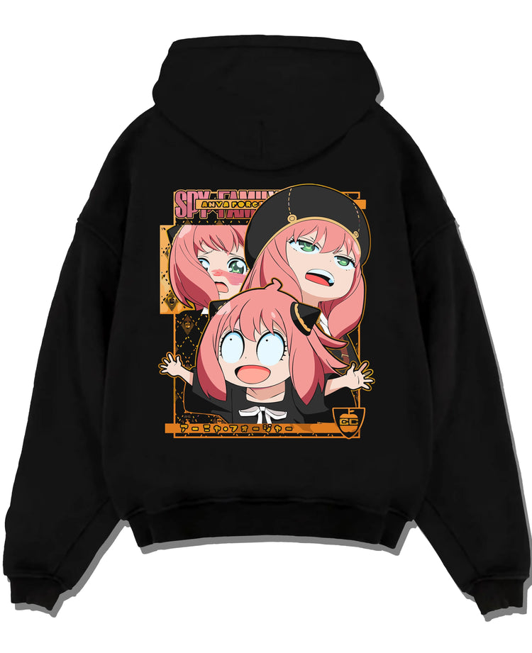 Black pullover hoodie laid flat with Anya Forger Hoodie Spy x Family Funny Faces Expression graphic premium wear.