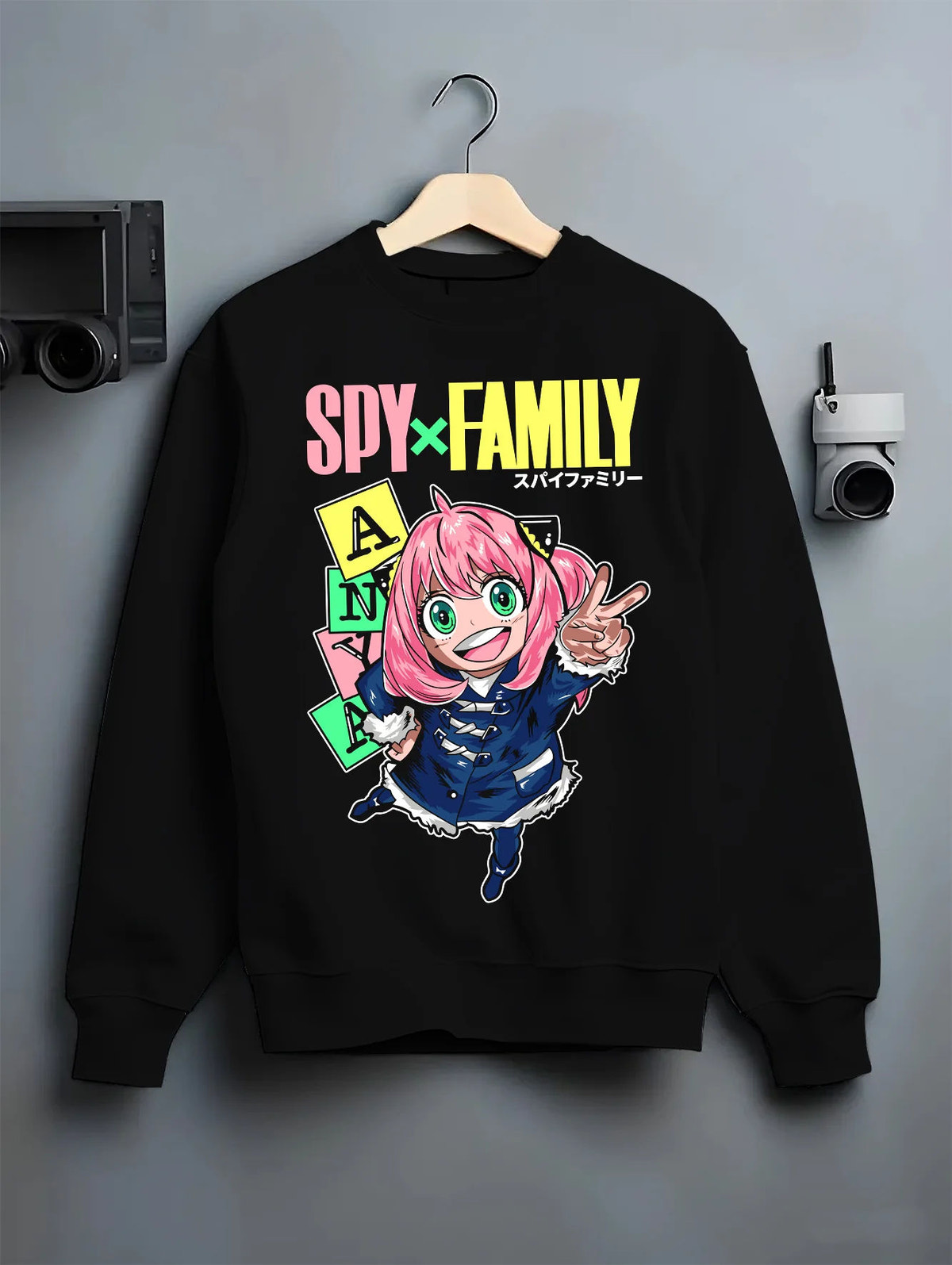 Black crewneck sweatshirt on hanger with Anya Forger from Spy x Family illustrated back graphic
