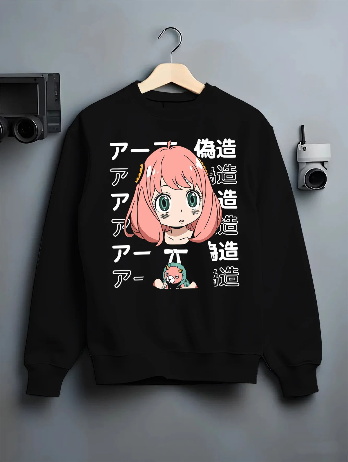 Black crewneck sweatshirt on hanger with Anya Forger from Spy x Family illustrated back graphic