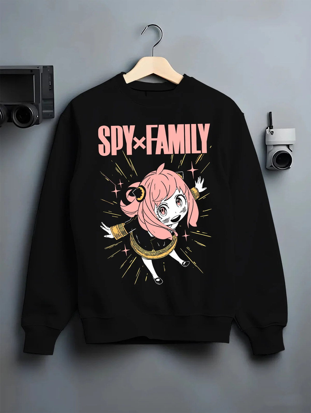 Black crewneck sweatshirt on hanger with Anya Forger from Spy x Family illustrated back graphic