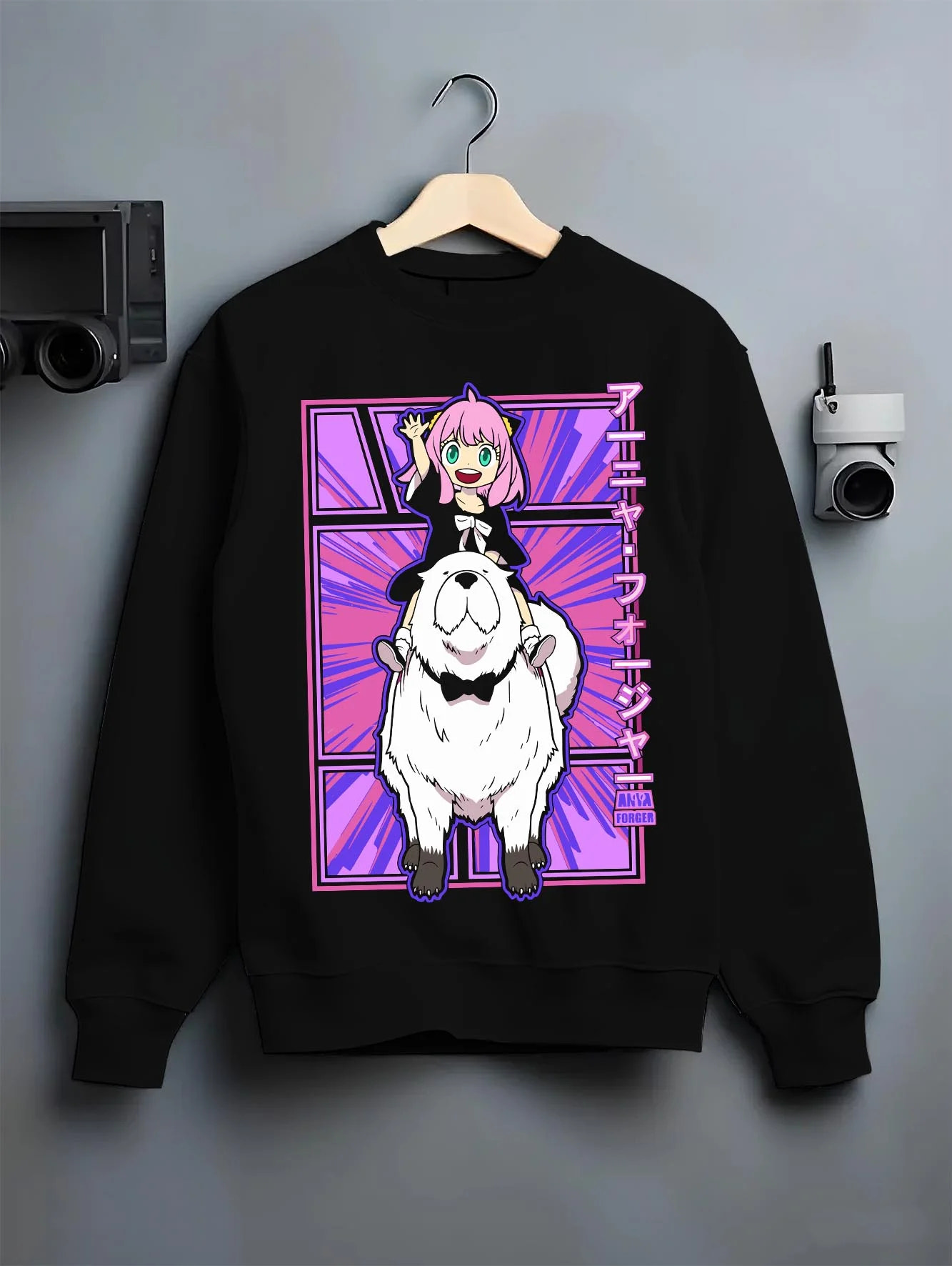 Black crewneck sweatshirt on hanger with Anya Bond Hoodie Spy x Family Forger Family Dog Print graphic bold anime graphic.